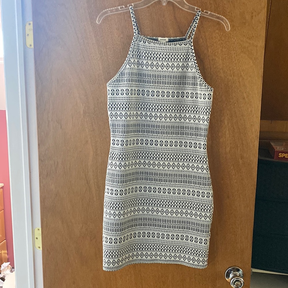 Form fitting, patterned, high neck mini dress.